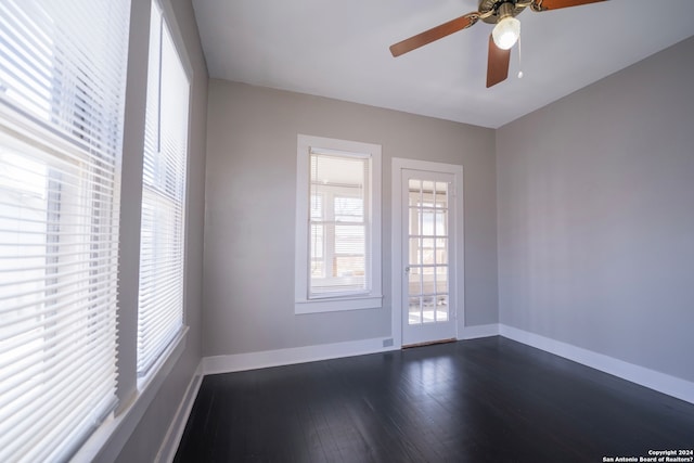 spare room featuring dark hardwood / wood-style floors and ceiling fan