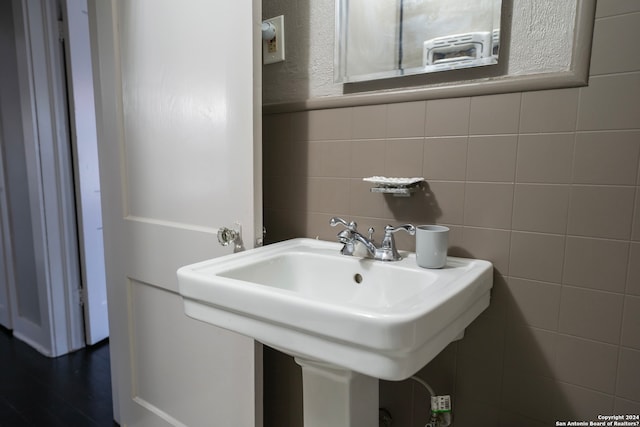 bathroom with tile walls and backsplash