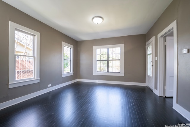 empty room featuring dark wood-type flooring