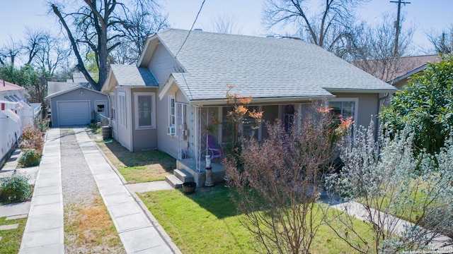 bungalow with a front lawn and a garage