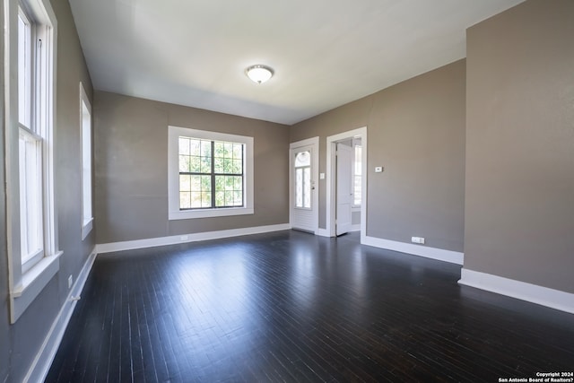 spare room with dark hardwood / wood-style floors