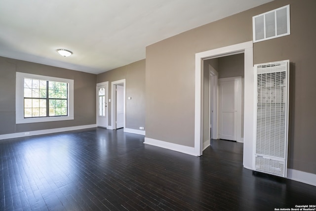 empty room with dark hardwood / wood-style flooring