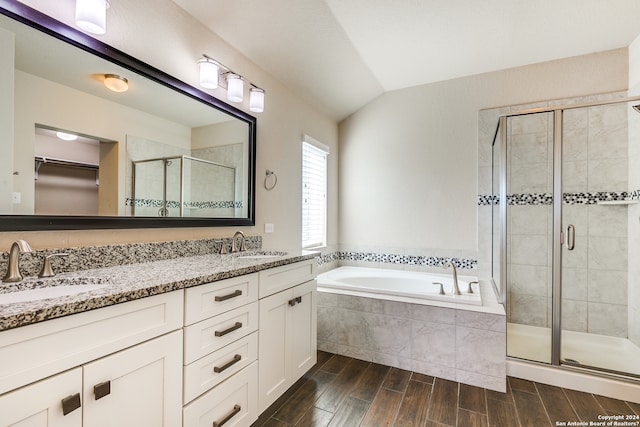 bathroom with a stall shower, a sink, a bath, and wood tiled floor