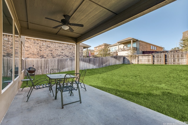 view of patio with ceiling fan, outdoor dining area, and a fenced backyard