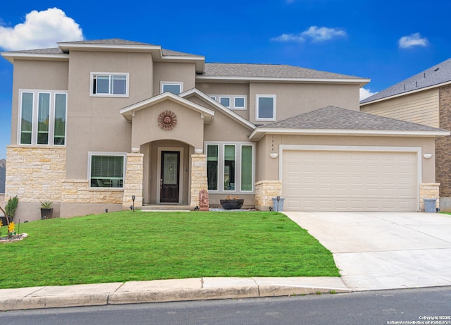 prairie-style home featuring a front yard and a garage