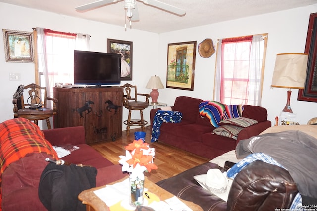 living room featuring ceiling fan, a wealth of natural light, and light wood-type flooring