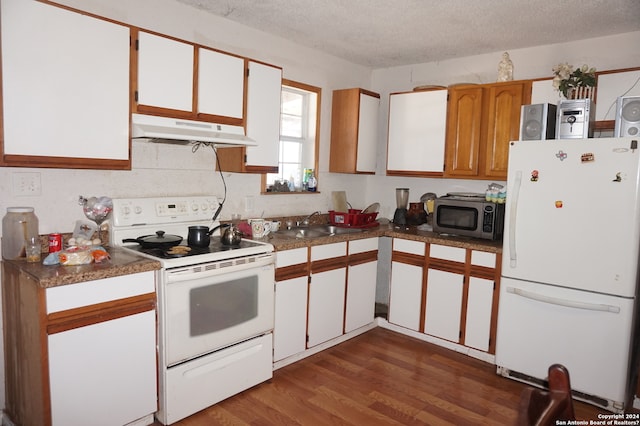 kitchen featuring white appliances, white cabinets, a textured ceiling, and dark hardwood / wood-style flooring