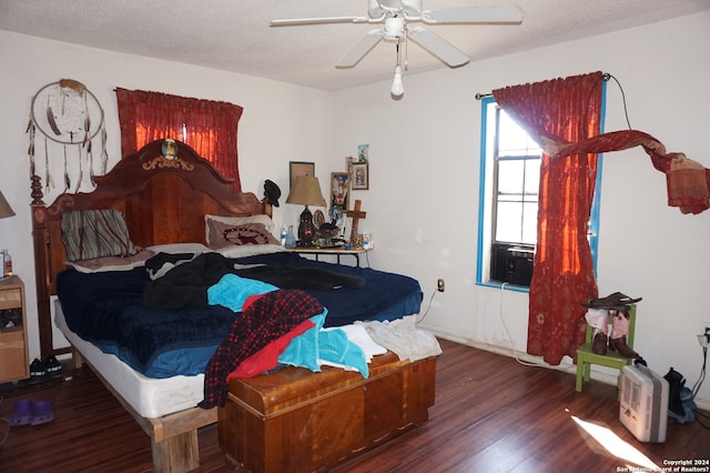 bedroom with dark hardwood / wood-style floors, a textured ceiling, and ceiling fan