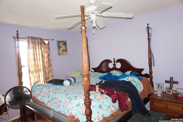 bedroom with a textured ceiling and ceiling fan