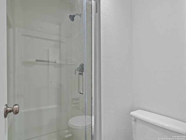 bathroom with walk in shower and toilet