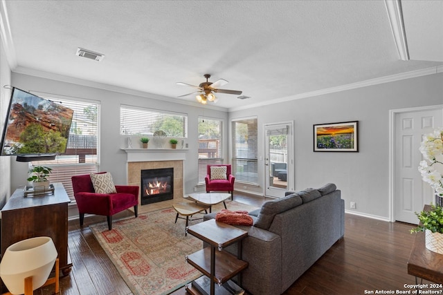 living room with ornamental molding, a fireplace, ceiling fan, and dark hardwood / wood-style flooring