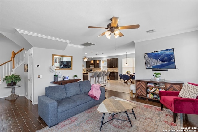 living room with ceiling fan, dark wood-type flooring, and ornamental molding