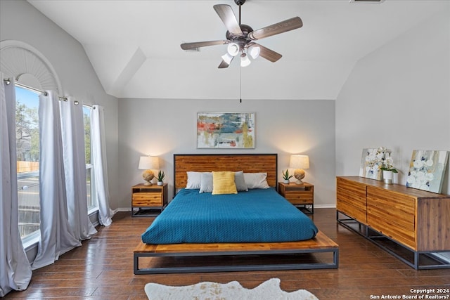 bedroom with ceiling fan, dark hardwood / wood-style floors, and vaulted ceiling