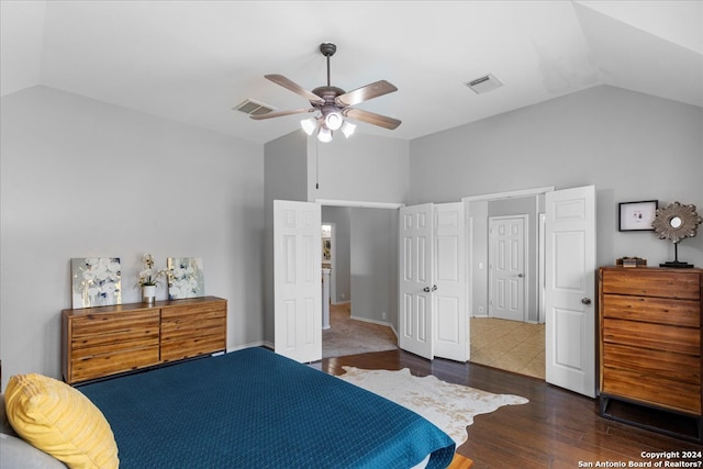 bedroom featuring dark hardwood / wood-style floors, ceiling fan, and lofted ceiling