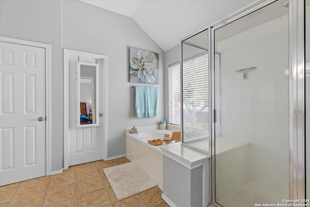 bathroom with separate shower and tub, tile floors, and vaulted ceiling