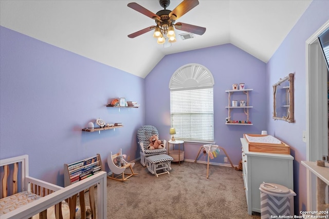 carpeted bedroom featuring ceiling fan, a crib, and vaulted ceiling