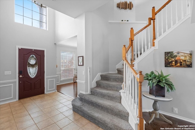 entrance foyer with light tile flooring and a high ceiling