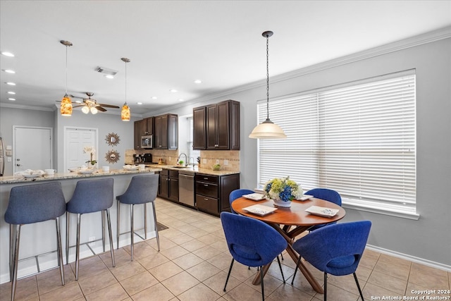 interior space featuring ceiling fan, sink, ornamental molding, and light tile floors