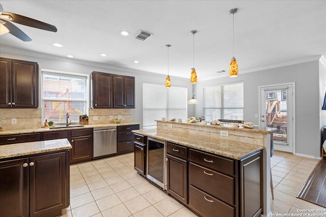 kitchen with pendant lighting, ceiling fan, dishwasher, and a wealth of natural light