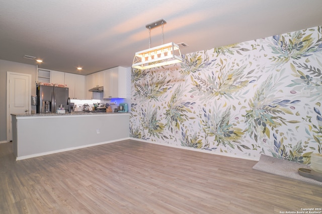 interior space with hardwood / wood-style floors, a notable chandelier, and sink