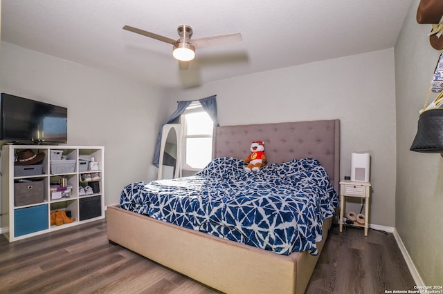 bedroom with ceiling fan and dark hardwood / wood-style flooring