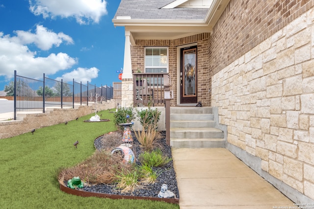 doorway to property with a yard