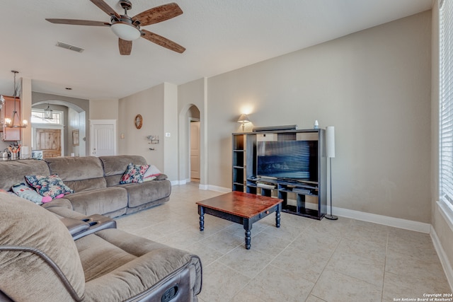 living room with ceiling fan and light tile flooring