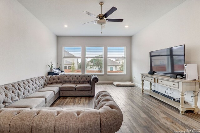 living room featuring ceiling fan and light wood-type flooring