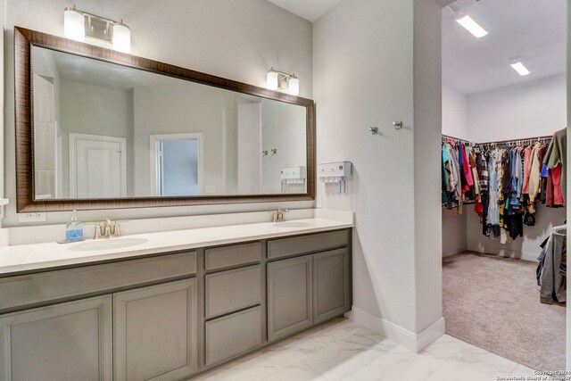 bathroom featuring tile floors and dual bowl vanity