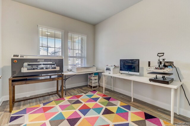 office with dark hardwood / wood-style flooring