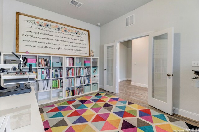 interior space featuring french doors and light hardwood / wood-style floors