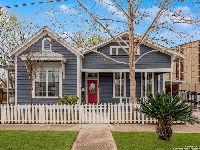 view of front of house featuring a porch and a fenced front yard