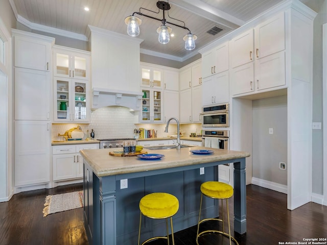 kitchen with dark wood finished floors, white cabinetry, a sink, and backsplash