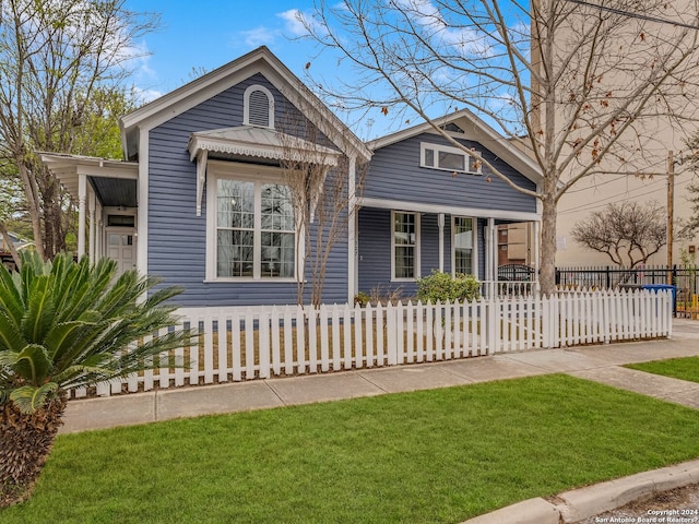 view of front of house with a porch and a fenced front yard