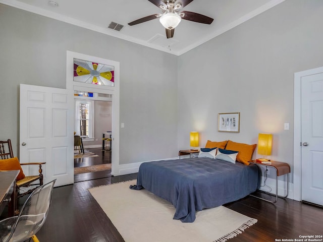 bedroom featuring ceiling fan, dark wood-type flooring, and crown molding