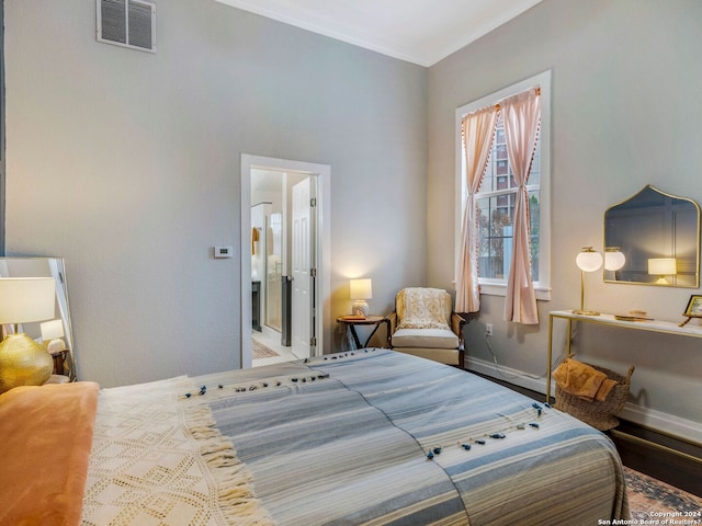 bedroom with baseboards, visible vents, and ornamental molding