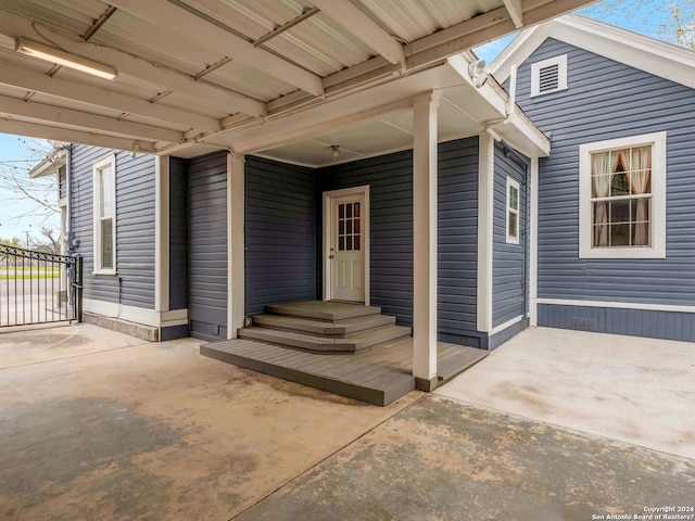 view of exterior entry with a patio