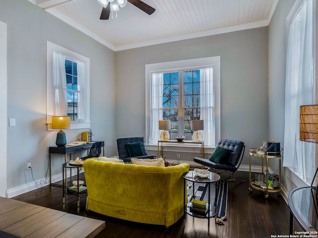 sitting room with baseboards, crown molding, and hardwood / wood-style floors