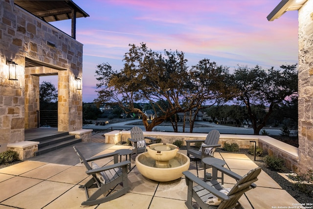 view of patio terrace at dusk