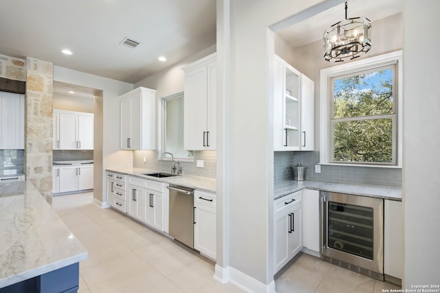 kitchen featuring white cabinets, backsplash, light tile patterned floors, stainless steel dishwasher, and wine cooler