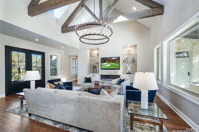 living room featuring a chandelier, dark hardwood / wood-style flooring, and beam ceiling