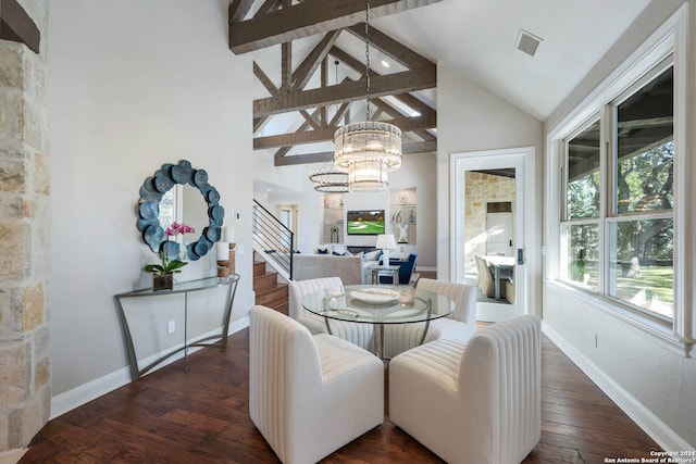 dining space with a chandelier, beamed ceiling, and dark wood-type flooring