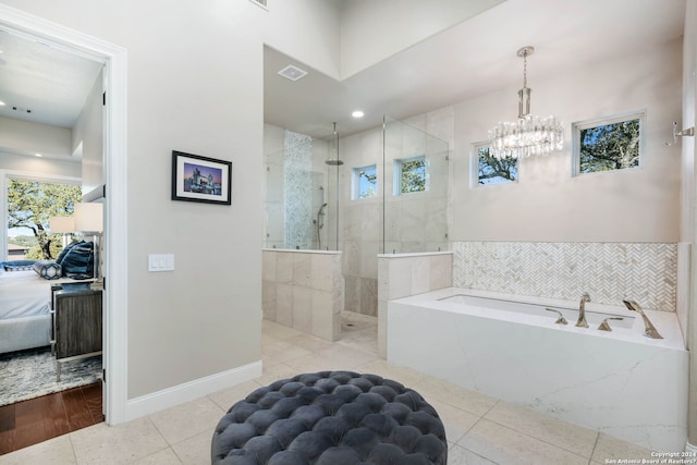 bathroom with hardwood / wood-style flooring, plus walk in shower, and a chandelier