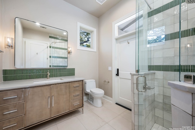 bathroom with tile patterned flooring, walk in shower, toilet, and vanity