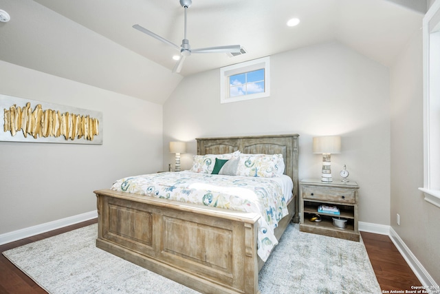 bedroom with dark wood-type flooring, vaulted ceiling, and ceiling fan