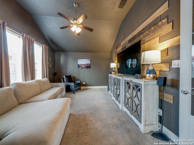 carpeted living room featuring ceiling fan and vaulted ceiling