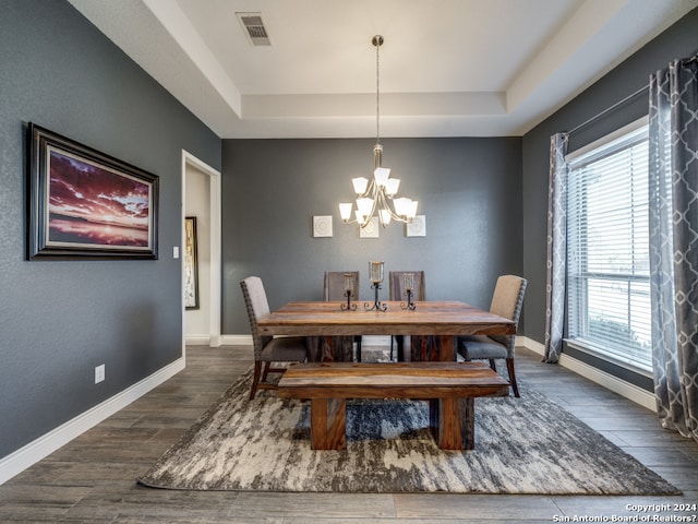 dining room featuring a wealth of natural light, a notable chandelier, and a tray ceiling