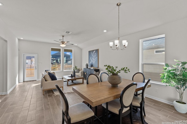 dining space featuring a wealth of natural light and ceiling fan with notable chandelier