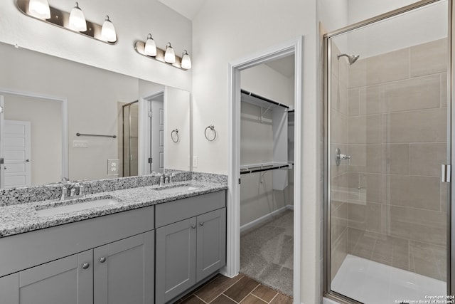 bathroom with vanity and a shower with shower door