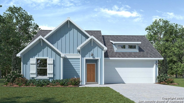 view of front of property with a garage and a front yard